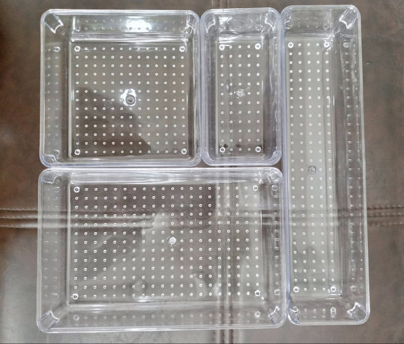 Zidello 4-Piece Acrylic Cosmetics Organizer Set – A stylish and clear acrylic storage set designed to organize makeup and beauty essentials. The set includes multiple compartments to neatly store and display cosmetics, offering both functionality and elegance.