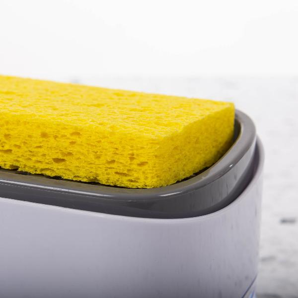 Soap dispenser with built-in sponge holder for a clutter-free sink.